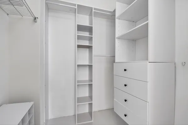 a room with two chair and white walls