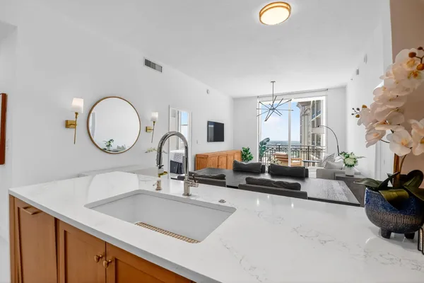 a kitchen with stainless steel appliances granite countertop a sink and a microwave