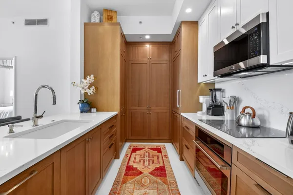 a view of a bedroom with wooden floor and windows