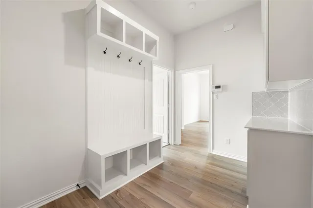 a view of an empty room with wooden floor