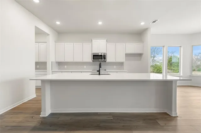 a kitchen with stainless steel appliances granite countertop a sink and cabinets