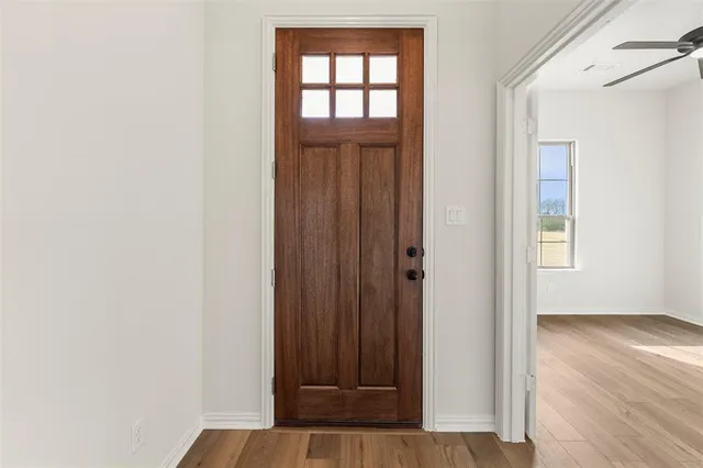 a view of front door with wooden floor