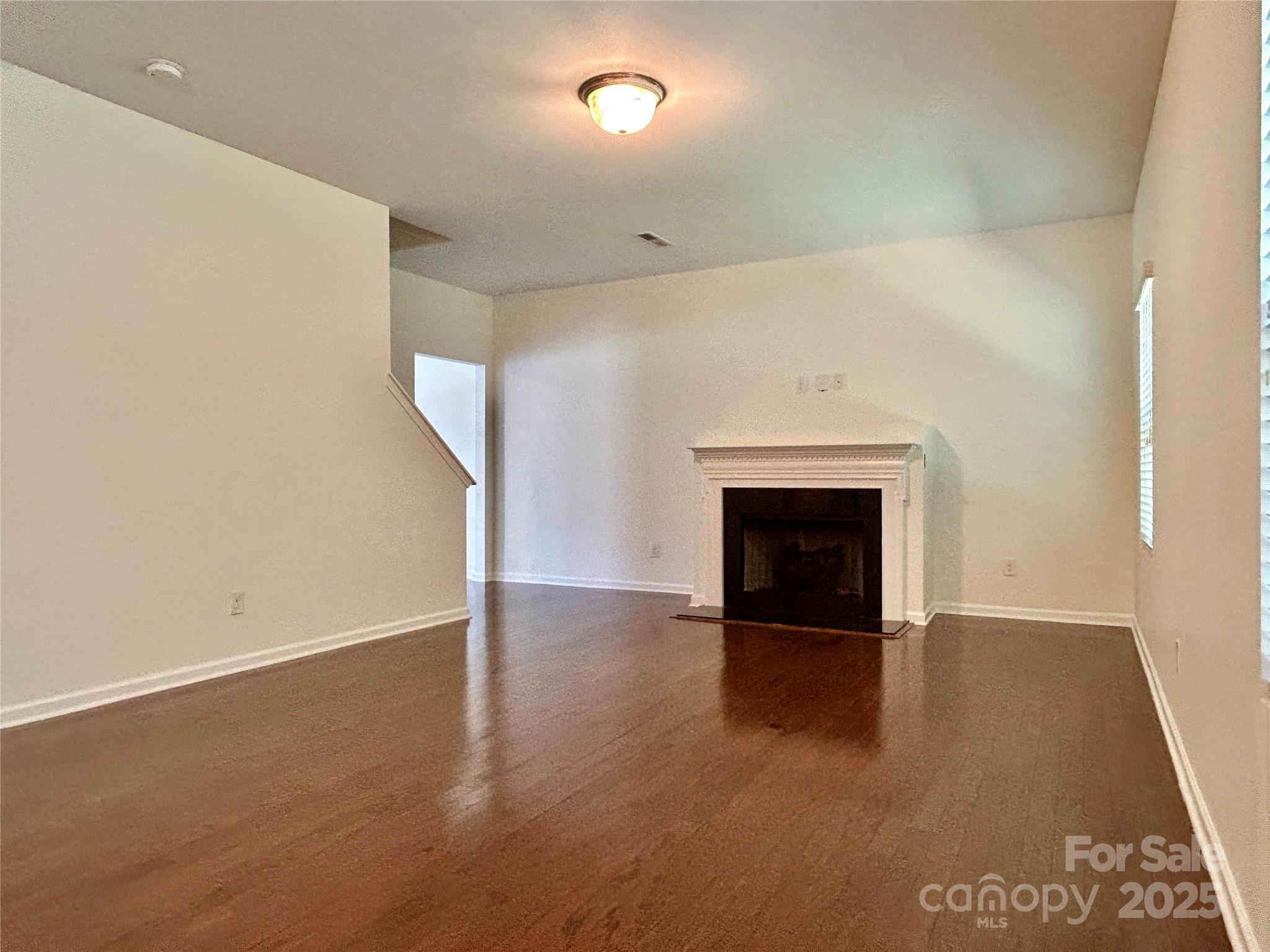 8320 Suttonview Drive Charlotte, NC 28269 - Photo 8 of 34 a view of an empty room with a fireplace