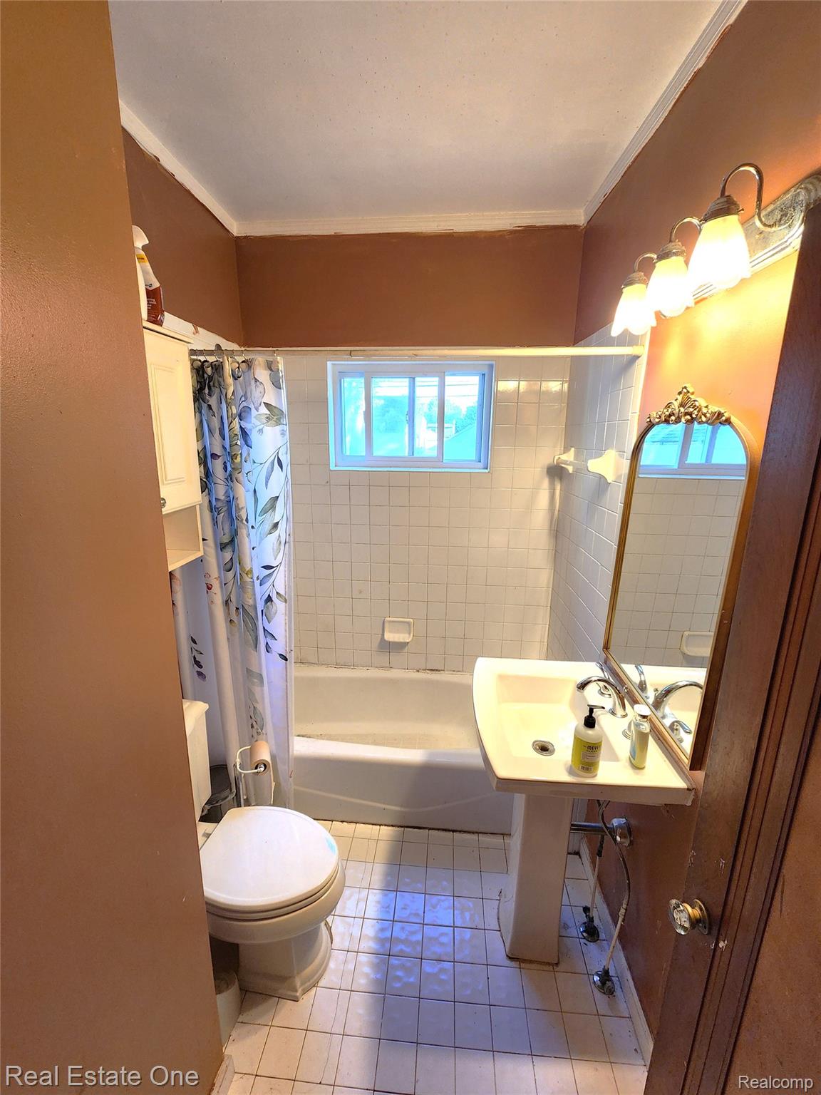 2153 Wiltshire Road Berkley, MI 48072 - Photo 16 of 18 Bathroom featuring a pedestal sink, a bathtub with white subway tile surround, and a window above the tub