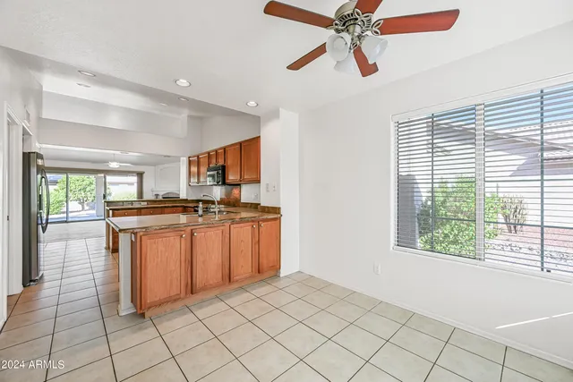 a view of a big room with wooden floor and windows