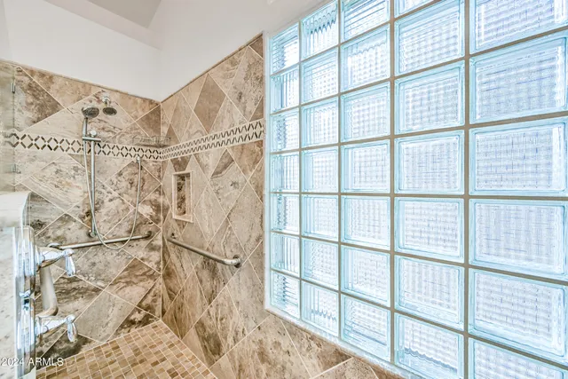 a bathroom with a sink a mirror and a shower