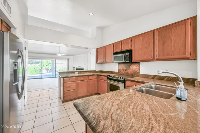 a kitchen with stainless steel appliances granite countertop a stove sink and cabinets