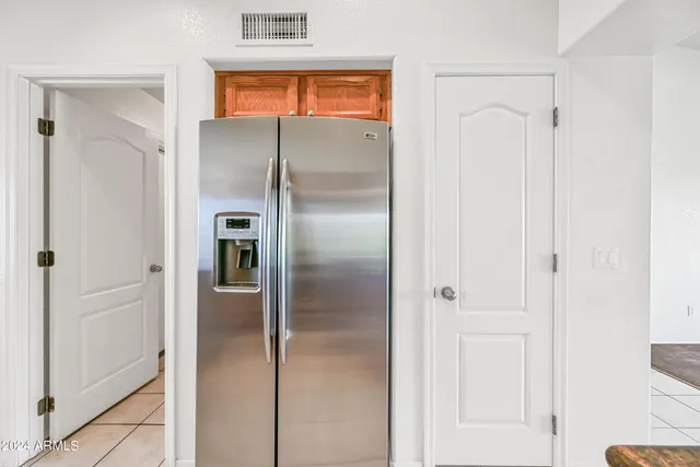 a large kitchen with stainless steel appliances granite countertop a refrigerator and a sink