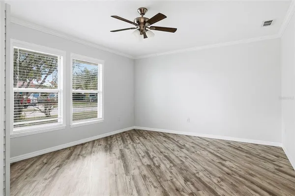 wooden floor in an empty room with a window