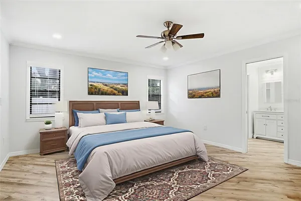 a bedroom with a large bed and a chandelier