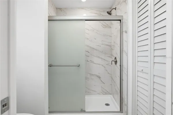 a bathroom with a glass shower door