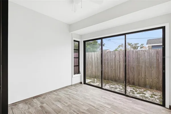 a view of a room with wooden floor and window