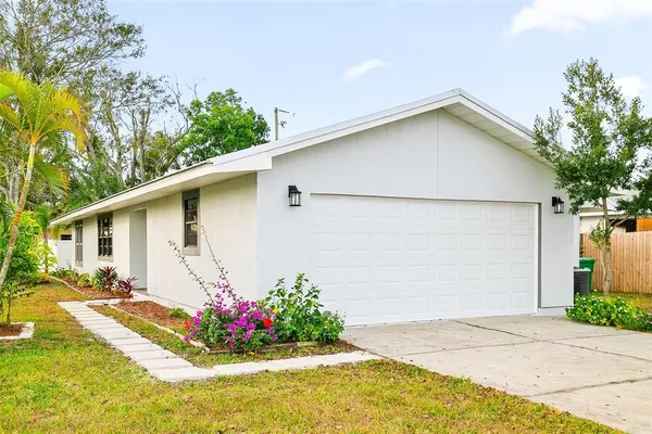 a view of backyard of house with outdoor seating