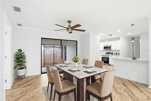a view of a dining room with furniture and wooden floor