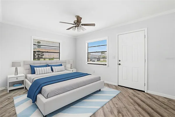 a bedroom with a large bed and a chandelier