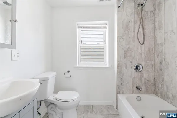 a bathroom with a sink a toilet and a bathtub