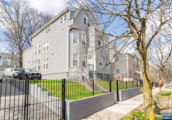 a view of a house with a wooden fence