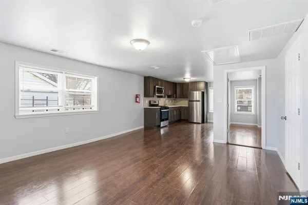 a view of kitchen with livingroom and wooden floor