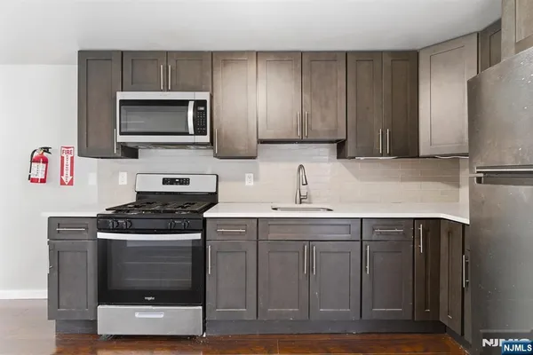 a kitchen with a sink and a refrigerator