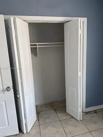 a view of closet with wooden floor