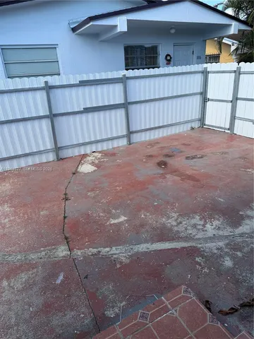 a view of a house with a fence