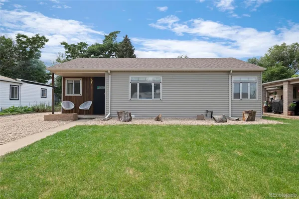 a backyard of a house with table and chairs