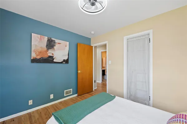 a bedroom with a bed and a painting on the wall