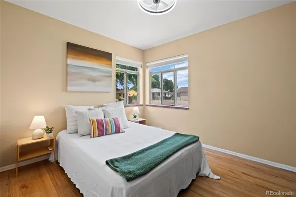 a bedroom with a bed and wooden floor