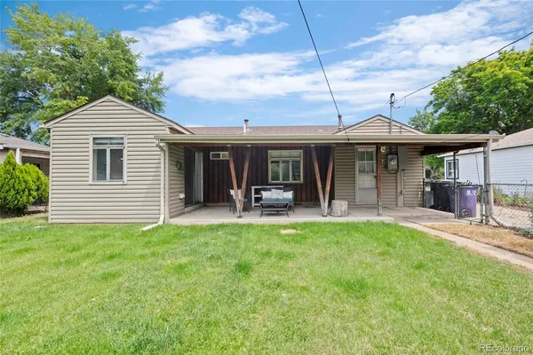 a view of a house with a swimming pool and sitting area