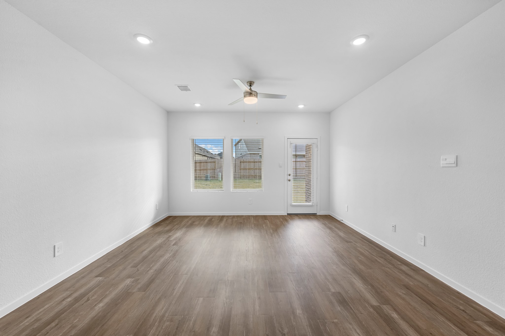 21915 Terre Riviera Drive Hockley, TX 77447 - Photo 13 of 33 an empty room with wooden floor and windows