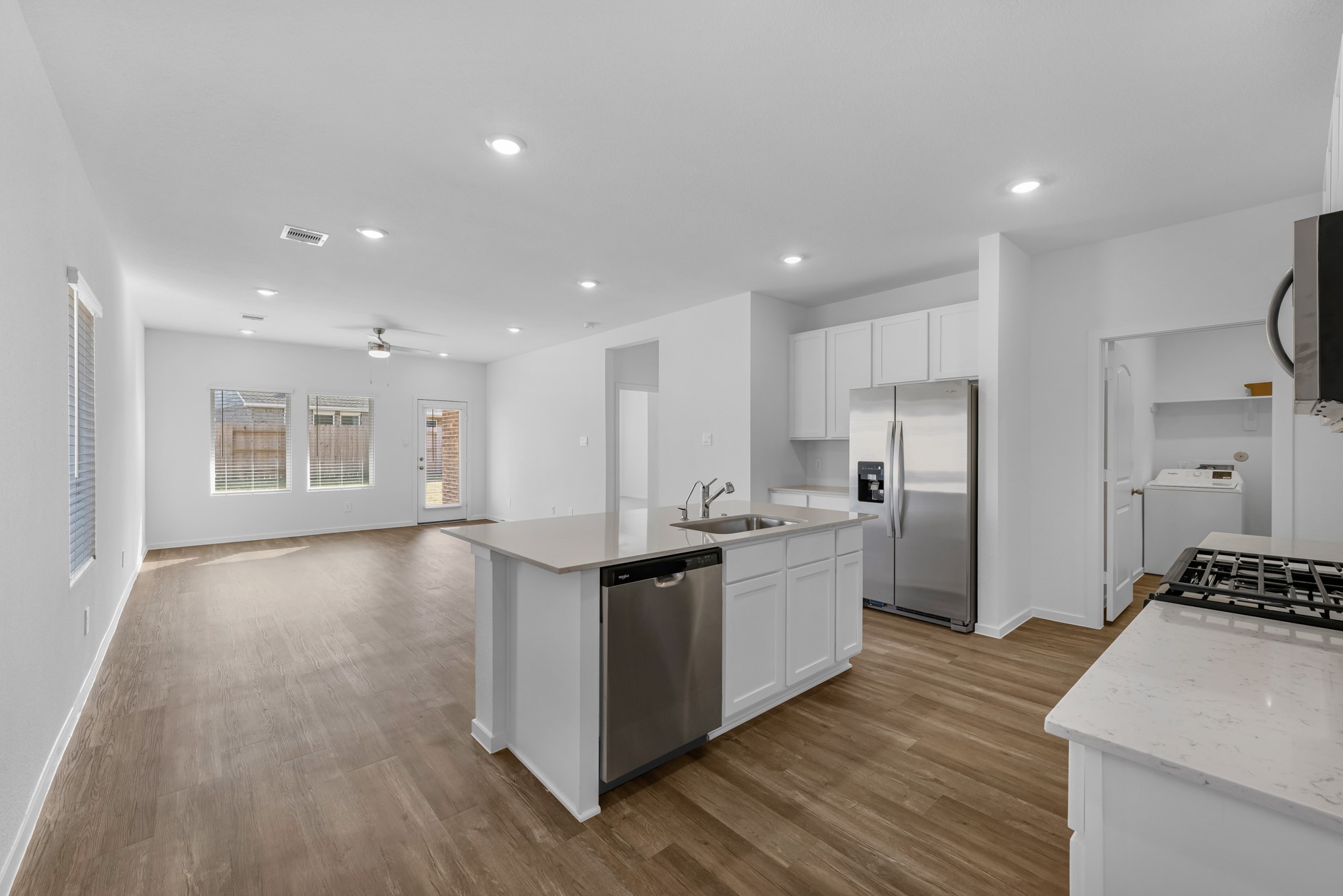 21915 Terre Riviera Drive Hockley, TX 77447 - Photo 8 of 33 a kitchen with stainless steel appliances kitchen island granite countertop a stove and a refrigerator