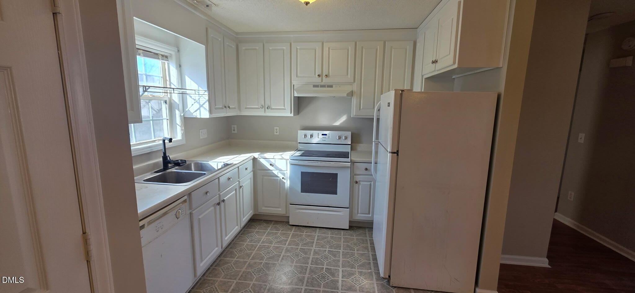 601 West Anderson Street Selma, NC 27576 - Photo 4 of 7 a kitchen with white cabinets and white appliances