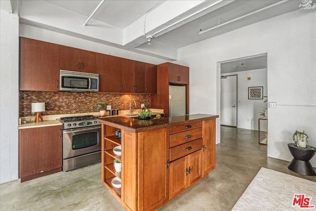 a kitchen with stainless steel appliances granite countertop a stove and a sink
