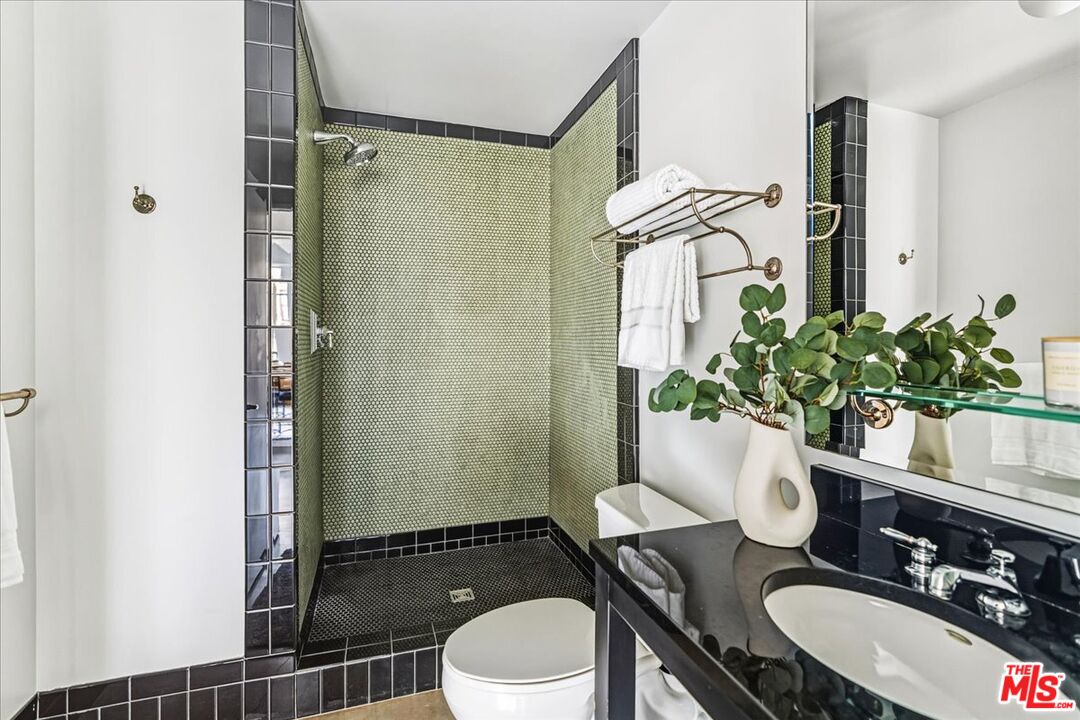 849 South Broadway, Unit 604 Los Angeles, CA 90014 - Photo 19 of 43 a bathroom with a granite countertop sink toilet and shower