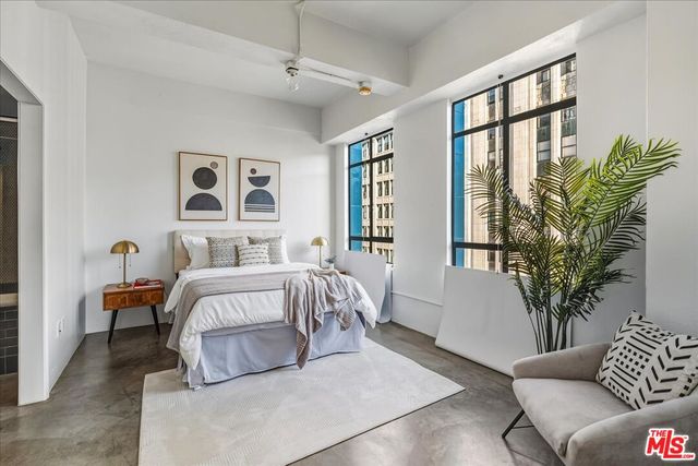 a spacious bedroom with a large bed and a couch