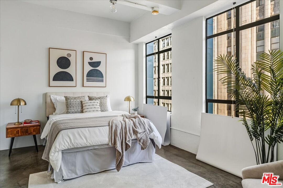 849 South Broadway, Unit 604 Los Angeles, CA 90014 - Photo 21 of 43 a bedroom with a bed and a large window with outer view