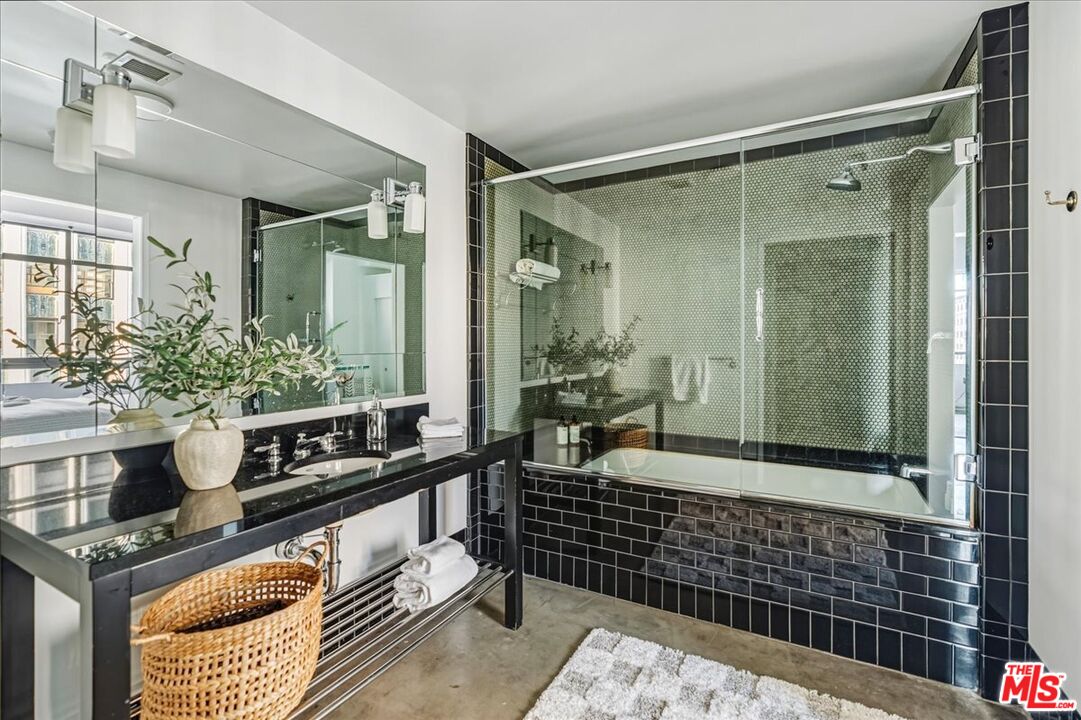 849 South Broadway, Unit 604 Los Angeles, CA 90014 - Photo 24 of 43 a bathroom with a shower a mirror and a sink