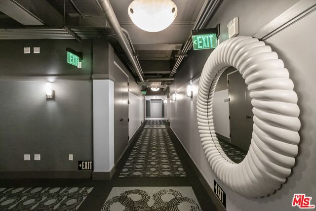 a room with furniture a mirror and clock on the wall