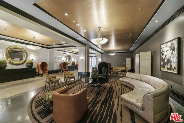 a living room with furniture and a chandelier