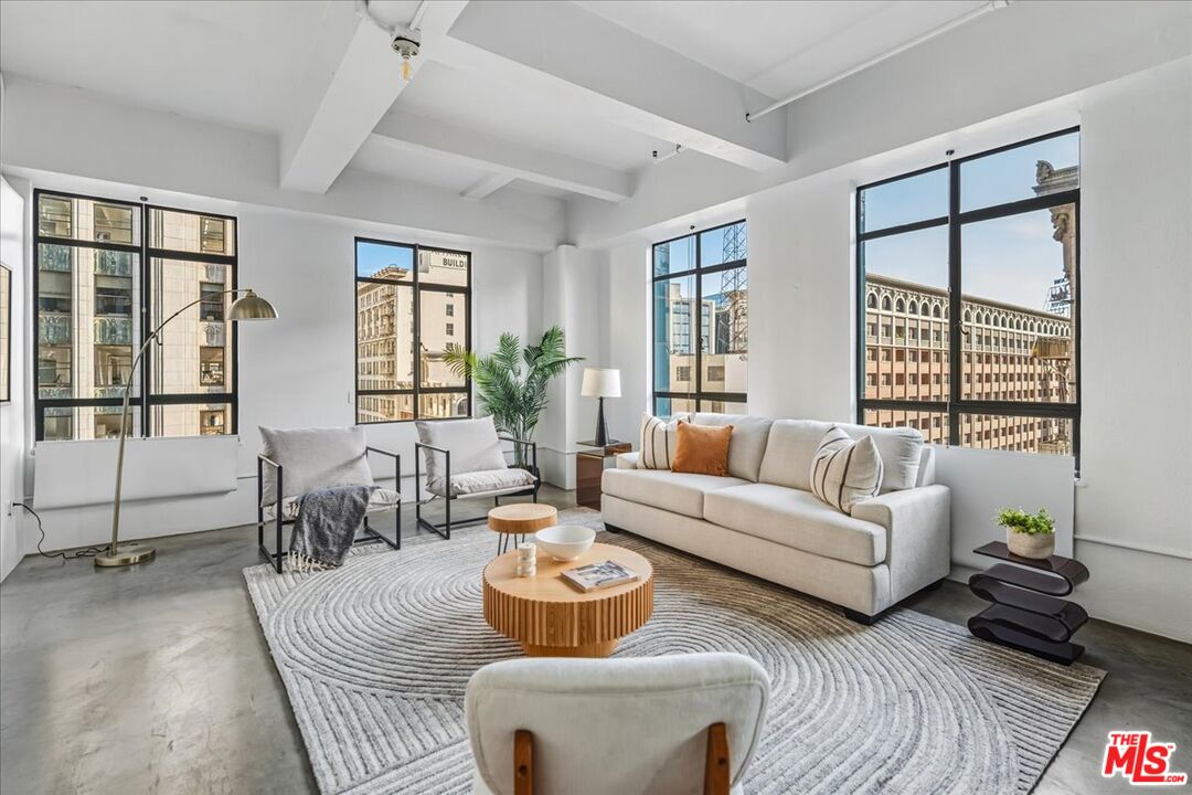 849 South Broadway, Unit 604 Los Angeles, CA 90014 - Photo 3 of 43 a living room with furniture and a large window