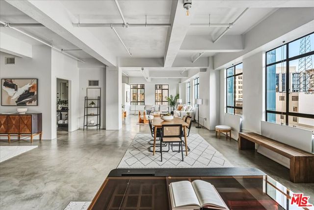a living room with furniture a rug and a large window