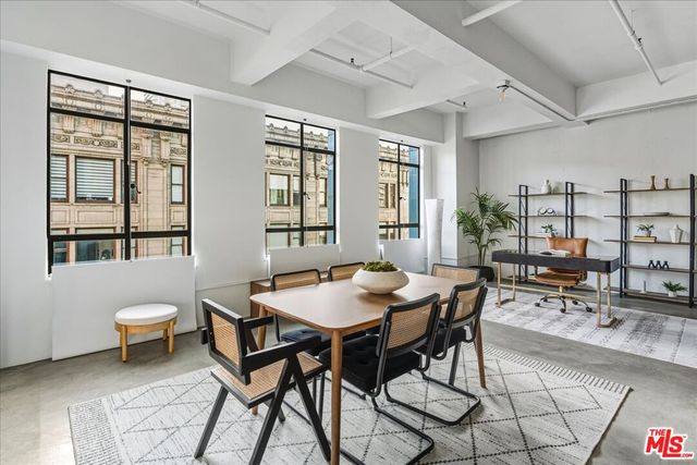 a view of a dining room with furniture and a potted plant