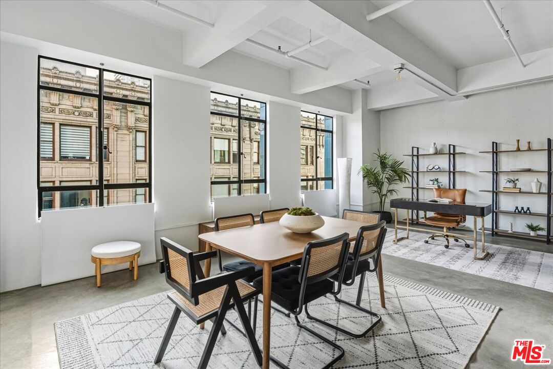 849 South Broadway, Unit 604 Los Angeles, CA 90014 - Photo 7 of 43 a view of a dining room with furniture and a potted plant