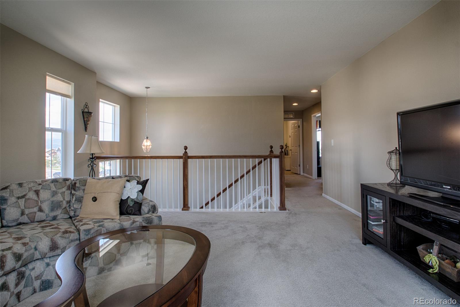 10459 Meadowleaf Way Highlands Ranch, CO 80126 - Photo 17 of 33 a living room with furniture and a flat screen tv