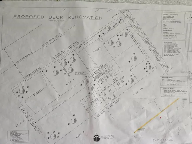 a view of a house with a yard and wooden fence