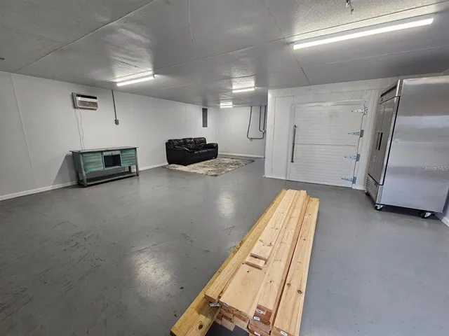 a view of kitchen with furniture and a refrigerator