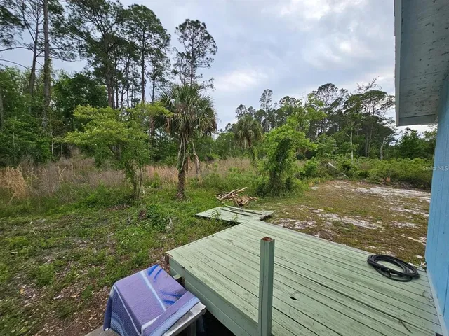 a view of a backyard with sitting area