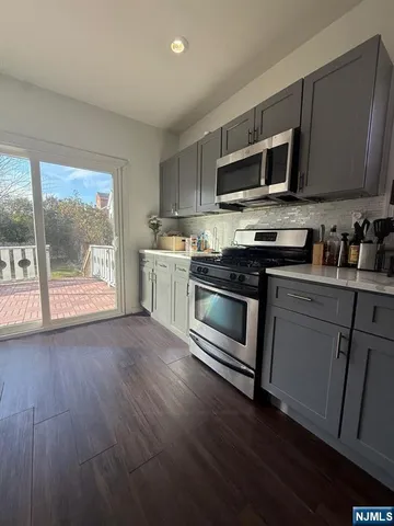 a kitchen with stainless steel appliances a stove a microwave sink and cabinets