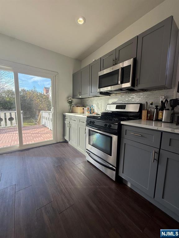 365 3rd Street Clifton, NJ 07011 - Photo 14 of 31 a kitchen with stainless steel appliances a stove a microwave sink and cabinets