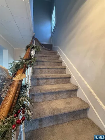 a view of a hallway with wooden shelves